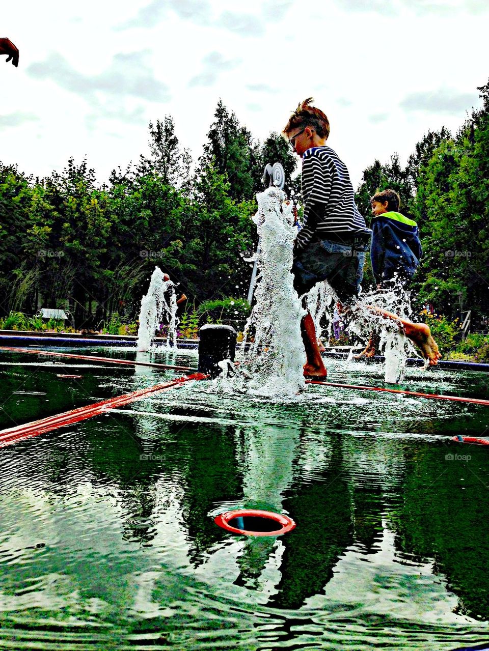 Playful guys running around spouting water!