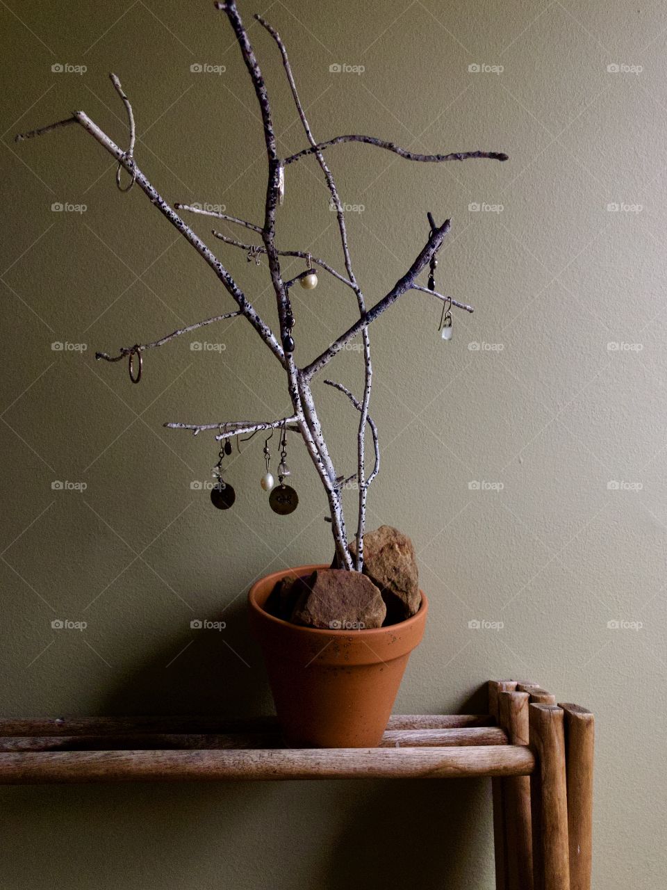 Jewelry holder made from branches rocks and flower pot