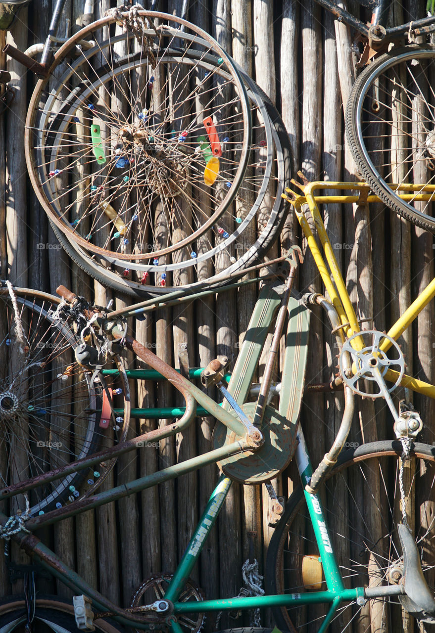 Bicycles hanging on a log fence