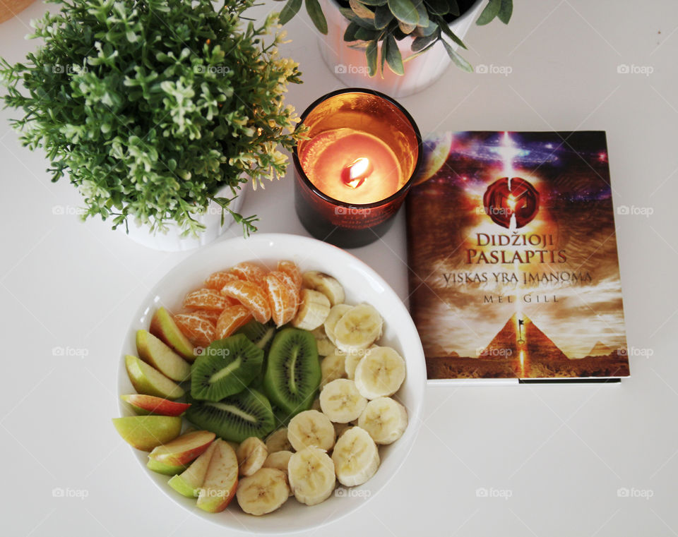 relaxing evening with candles, fruit and books