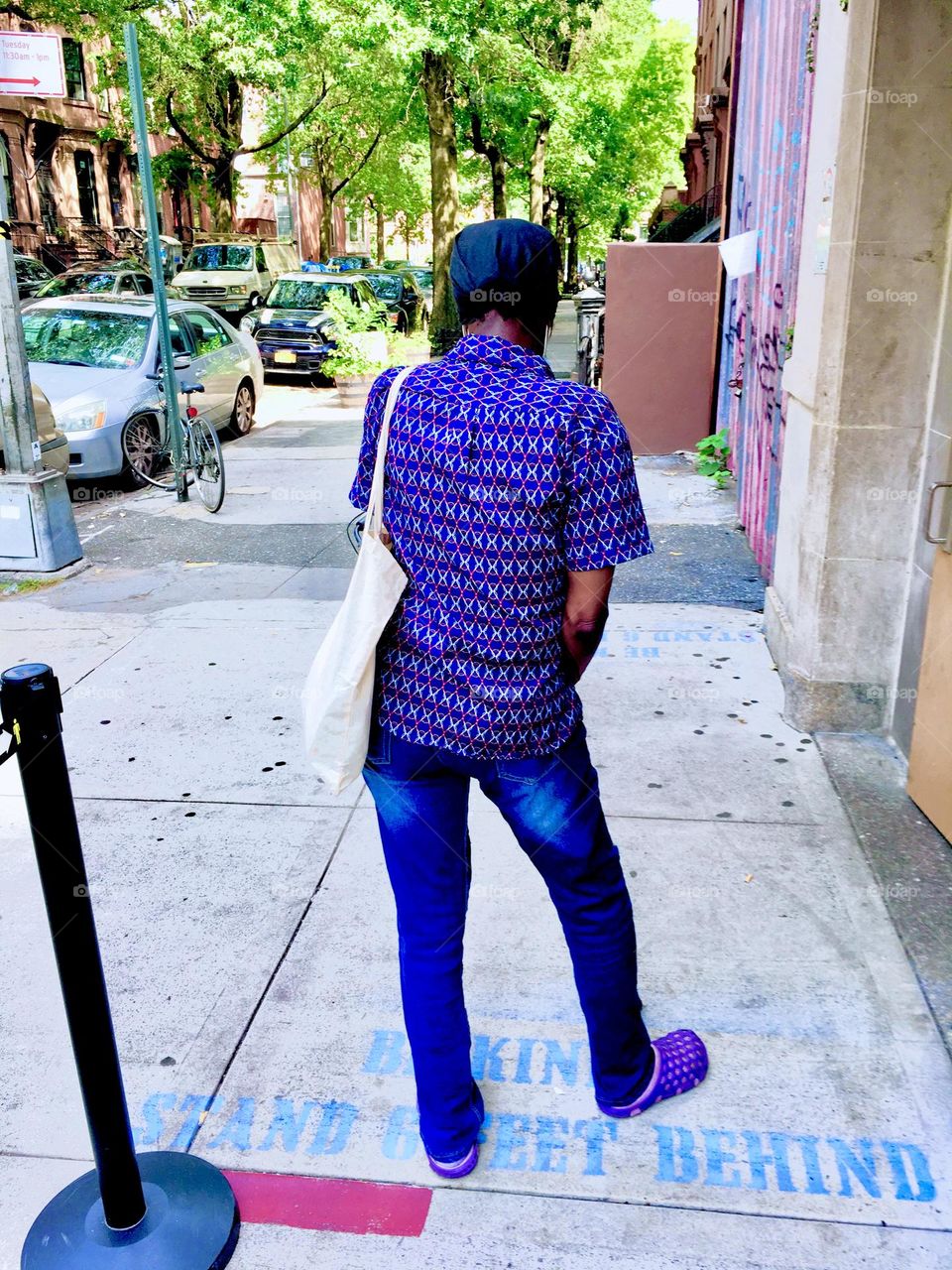 This lady is getting impatient. The demarcation line says clearly not to cross it and to practice social distancing. This goes back to the days of COVID. The door will soon open again to let the next group of patients in. 2020. Hypnotic Productions