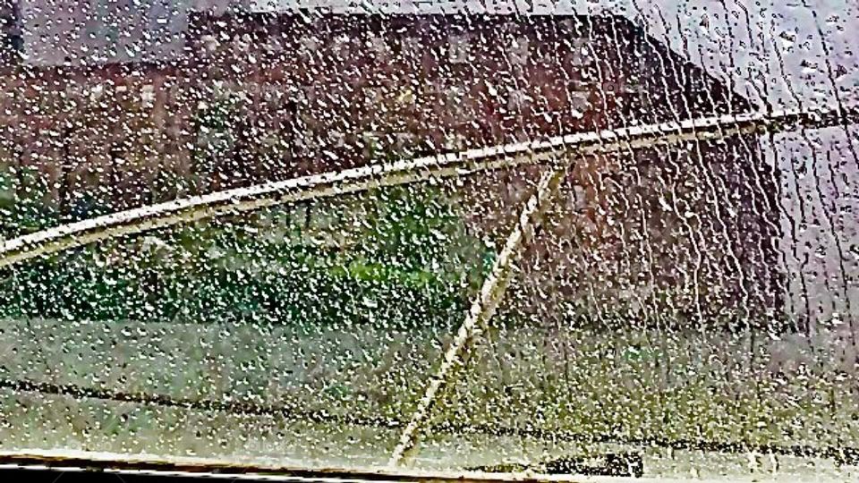 A view of the large brownstone building on the Greenpoint, Brooklyn side of the East River at Newtown Creek in Long Island City, Queens seen through the window of our boat we call the „Salvation“ on a rainy afternoon in 2018. Hypnotic Productions