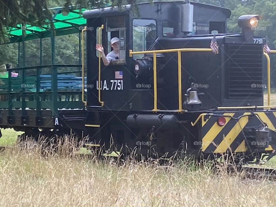 Close-up of train ride at a local park from an adjacent field. The conductor obliged with a wave. 