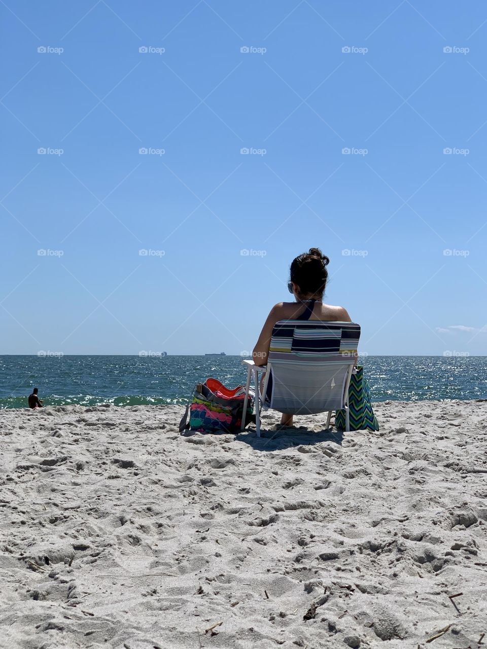 A woman sitting on the beach chair 