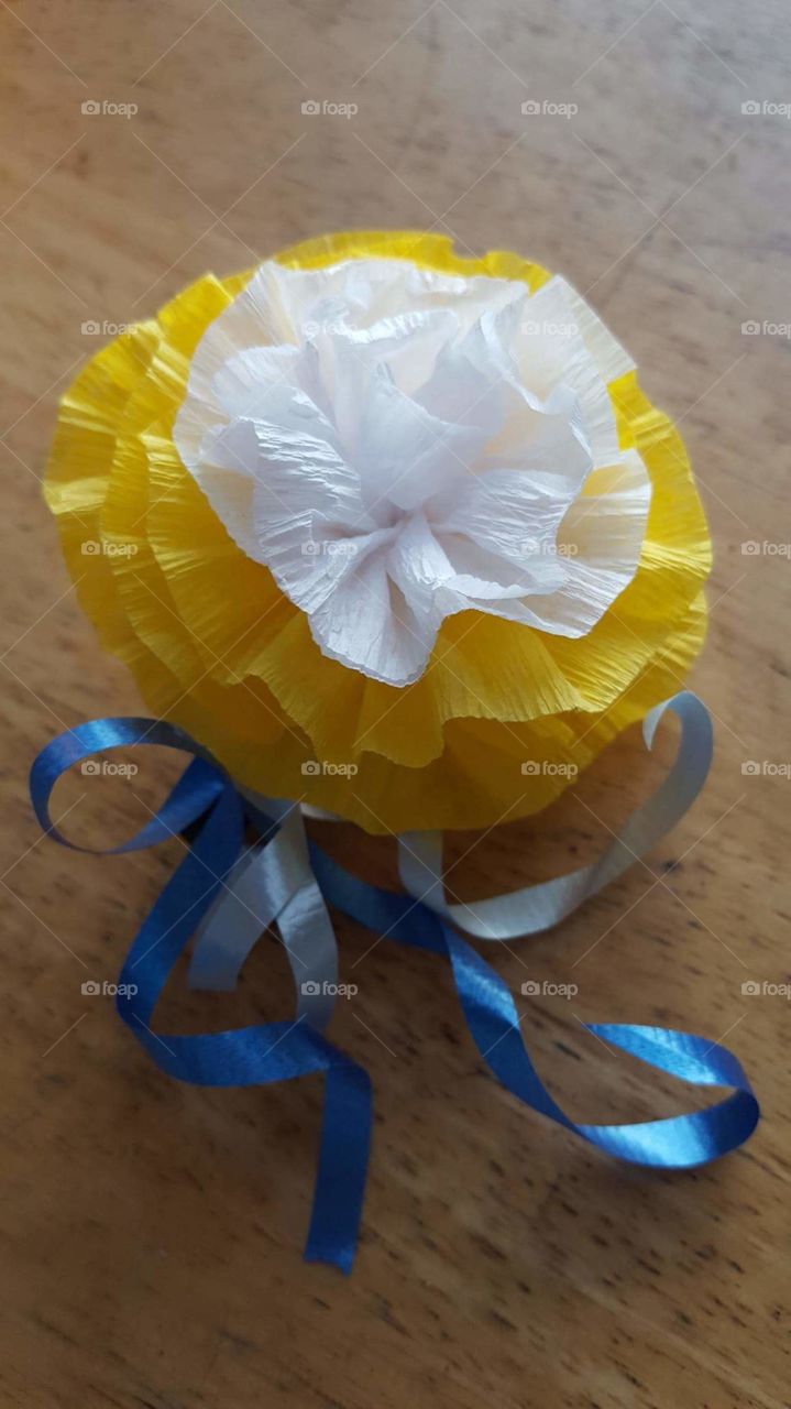 Home made flower botunier  made from crepe paper, floral tape ,needle and thread also ribbon and floral wire.