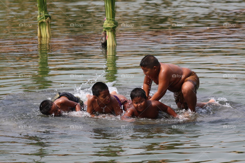 Children playing water Stuttgart, Thailand.