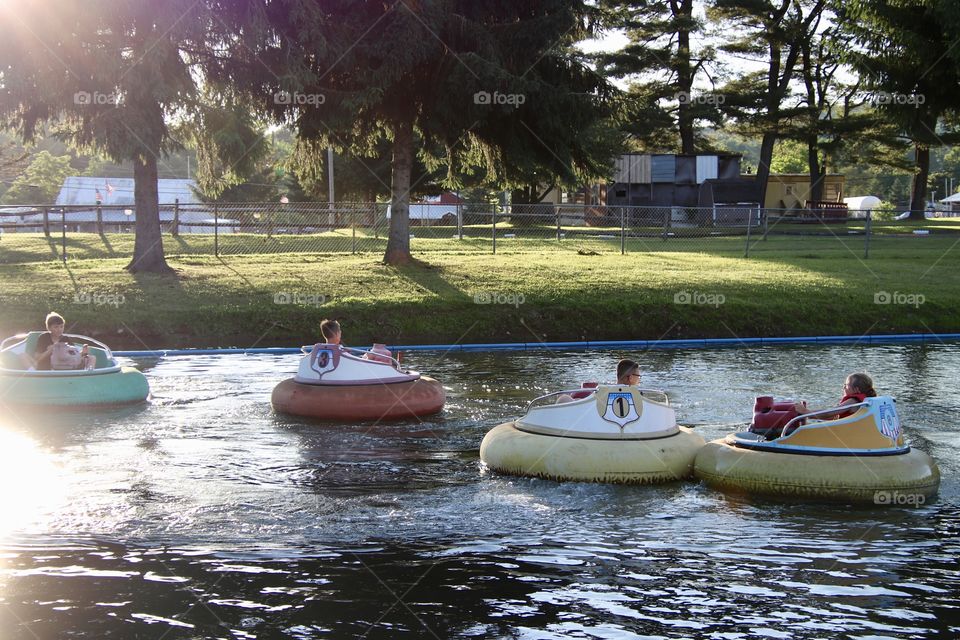 Kids riding bumper boats in summertime 