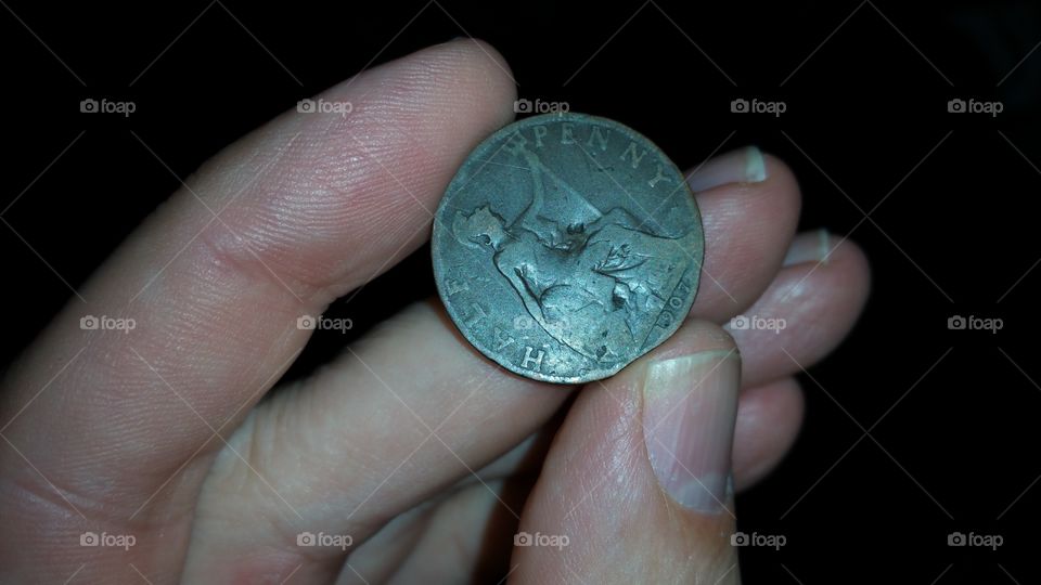 fingers holding old coin