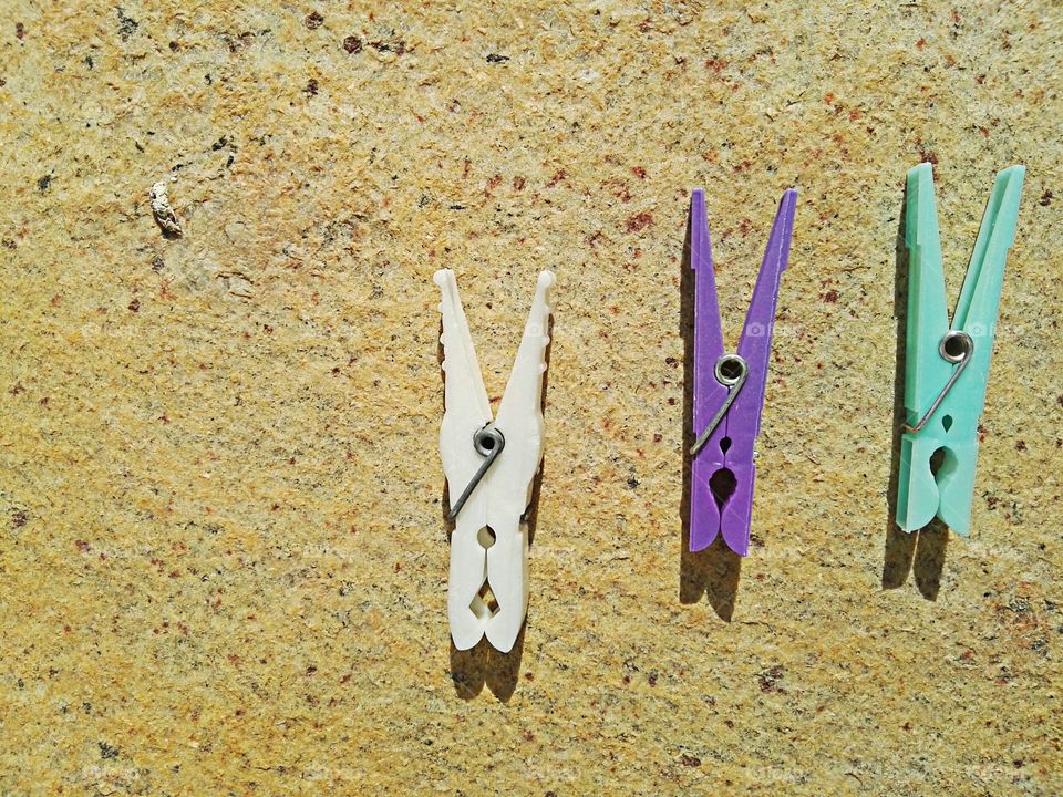 colored clips on stone background