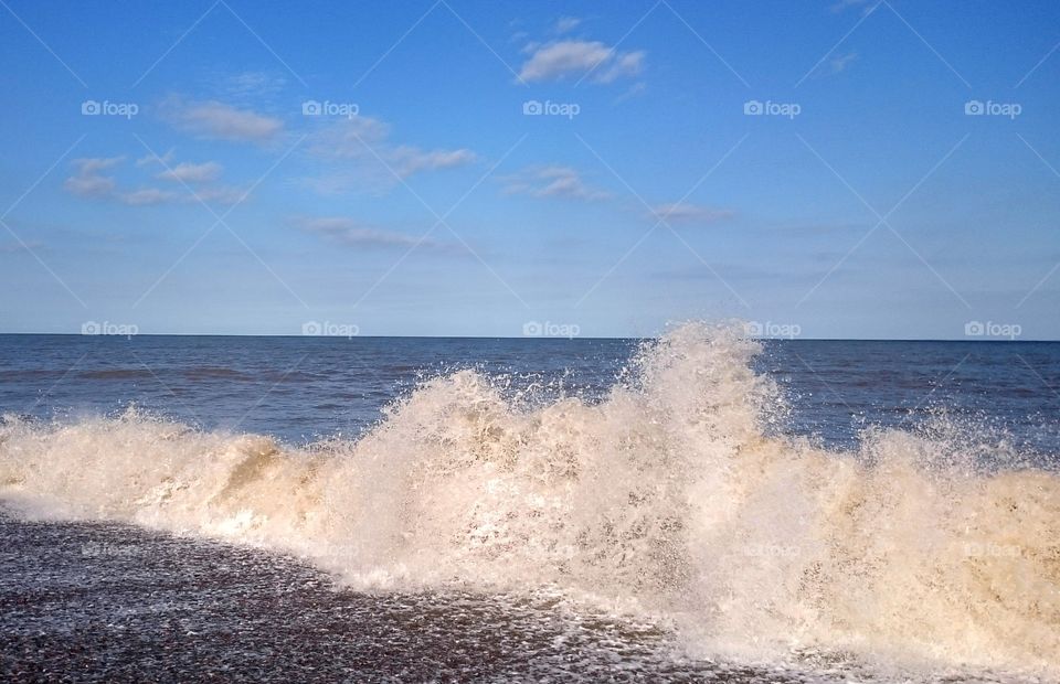 sea spray in Suffolk. waves crashing against Suffolk beach causing sea spray