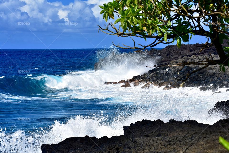 The waves crashing on the lava rock on Government Beach Road on the east side of the island of Hawaii 
