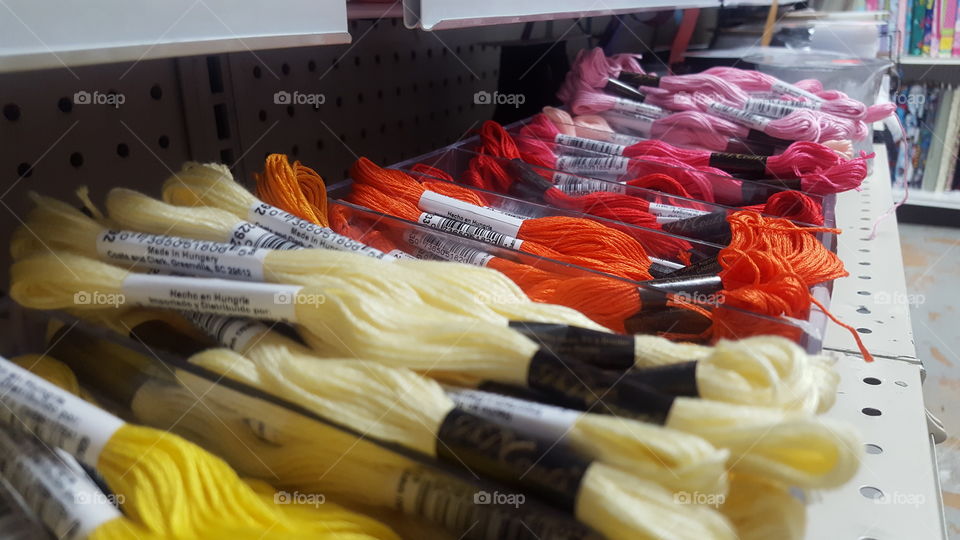 assorted collection of colorful yarn on store shelf