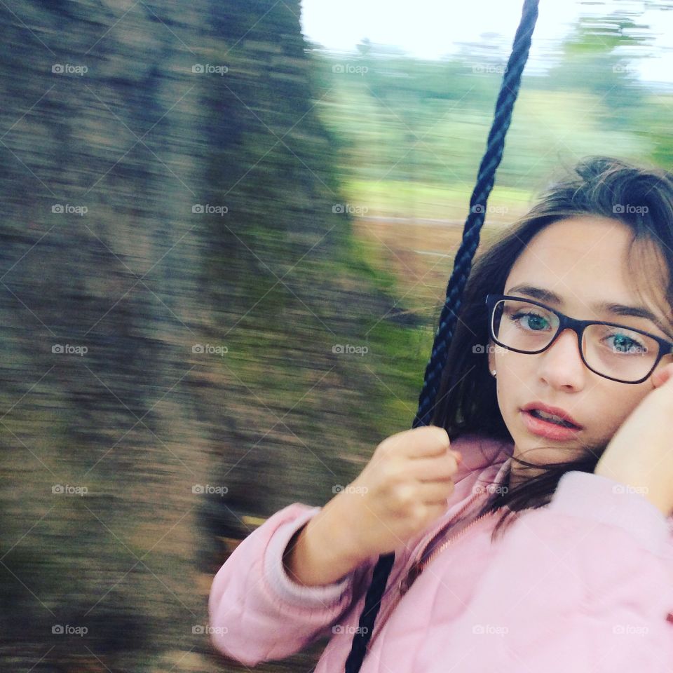 Girl on rope swing
