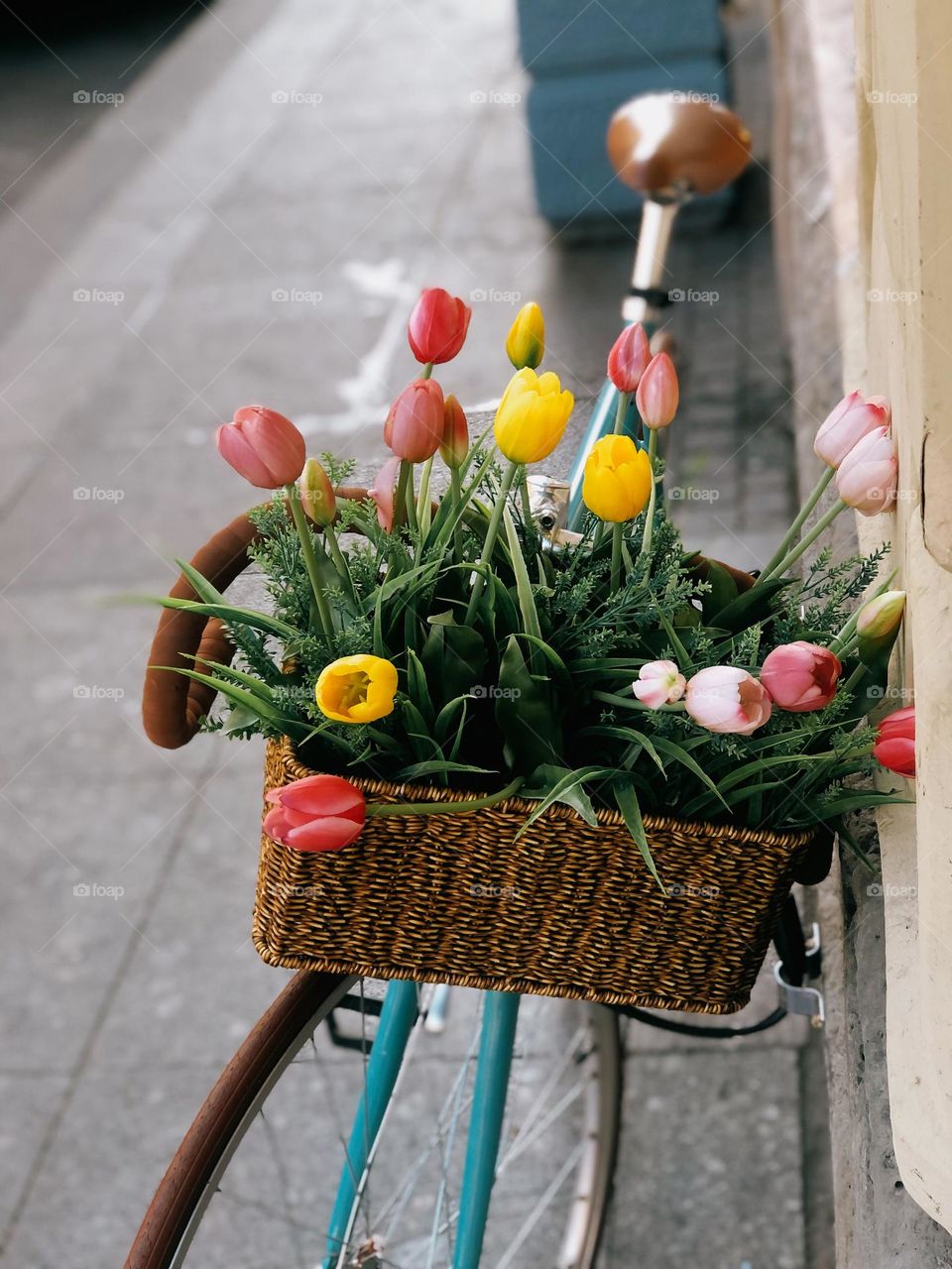 Lonely bicycle with colourful flowers on a street in summer day, nobody 