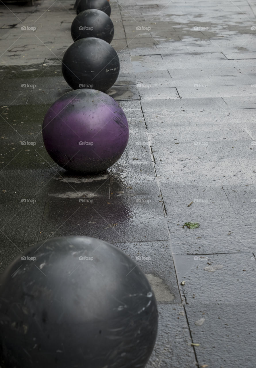 Decorative balls on the sidewalk on a rainy day of spring
