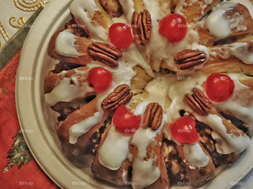 Frosted holiday tea ring with walnuts and candied cherries
