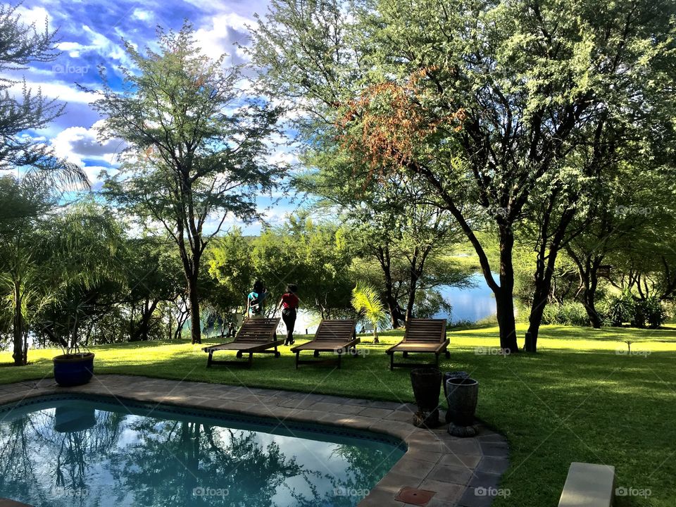 Good out for a swim, pool next to the river with a beautiful lawn and vegetation 