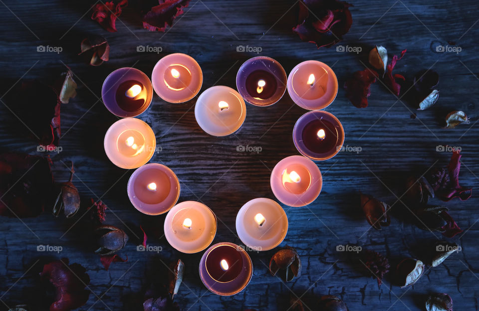 Candles and flowers in the shape of heart