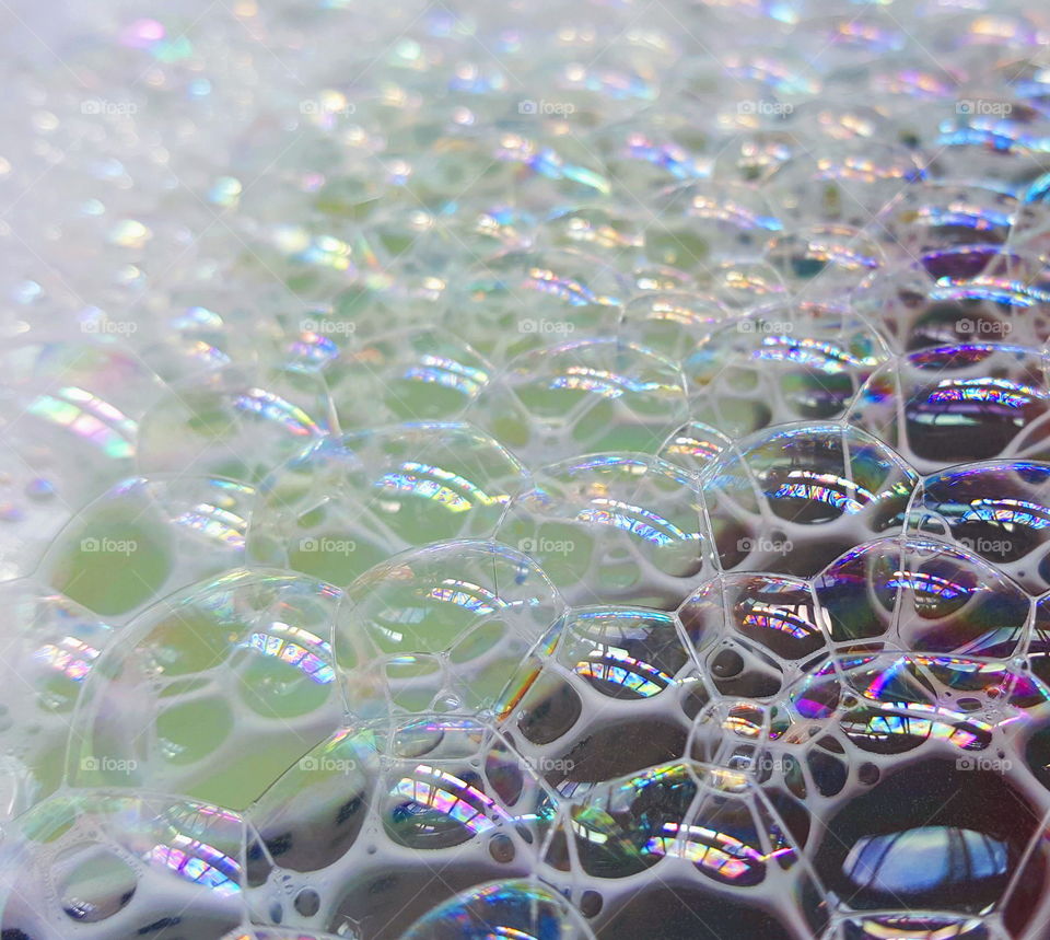 A layer of bubbles on water.