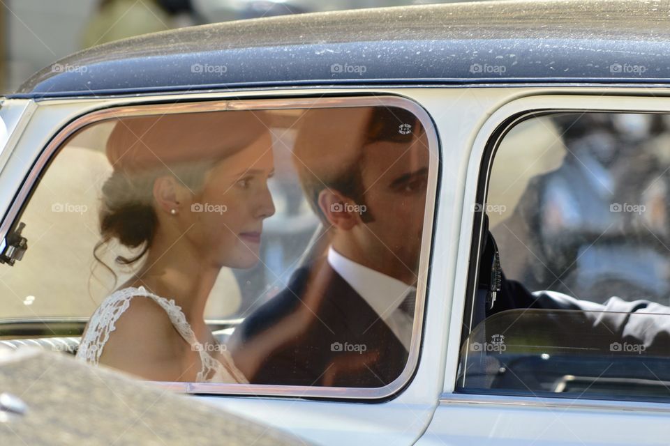 Bride in a small vintage car