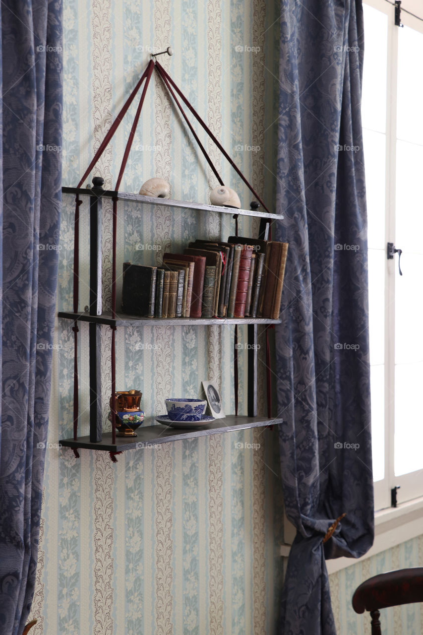 Antique wooden shelve with books and decorations