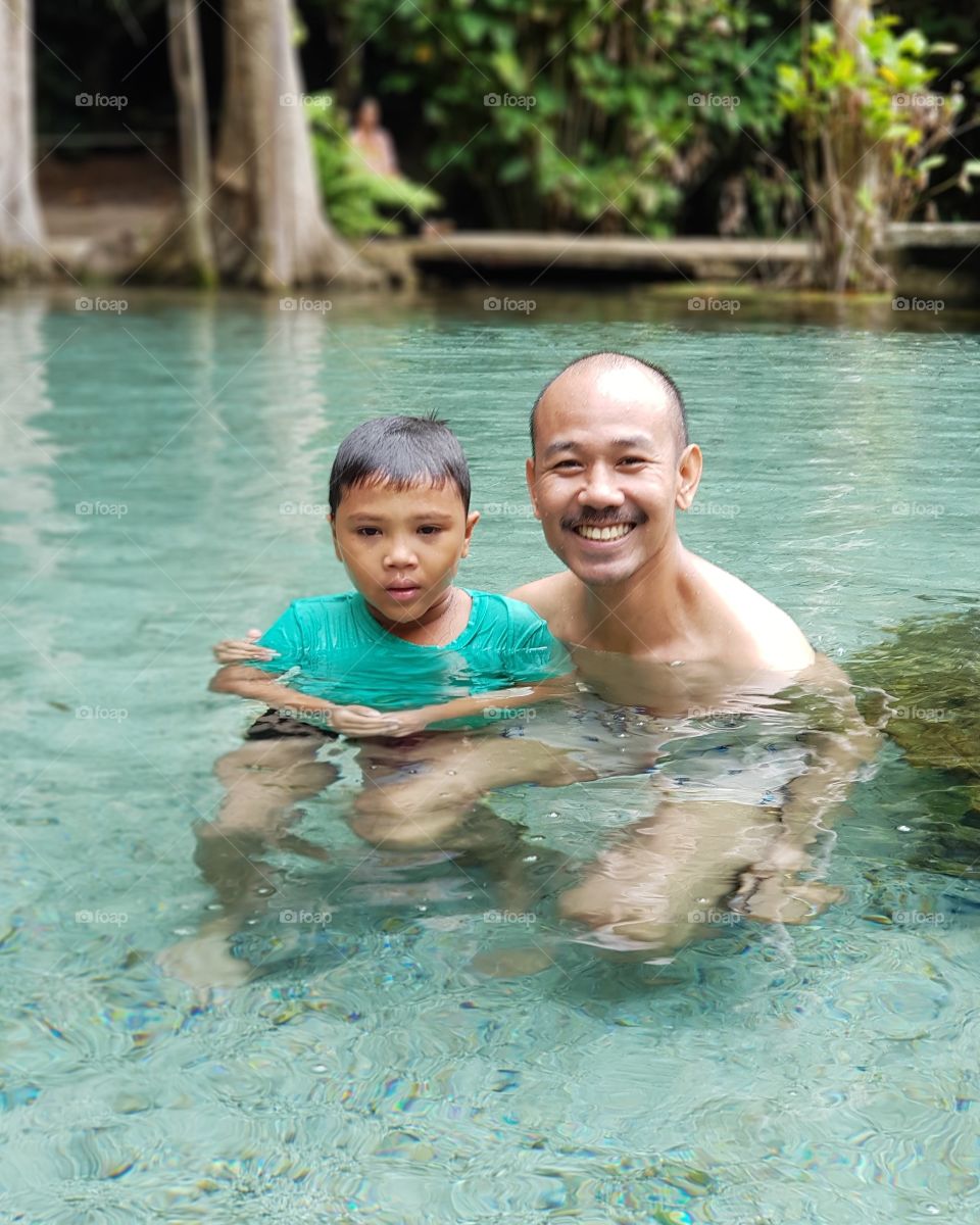 Family swimming in stream