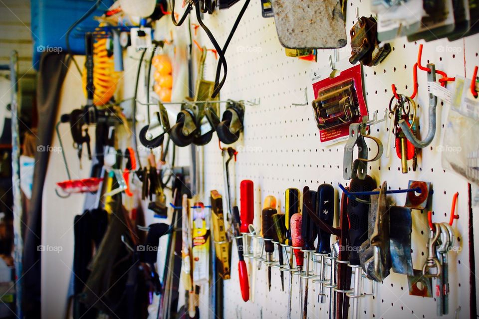 Many shop tools hanging on a pegboard