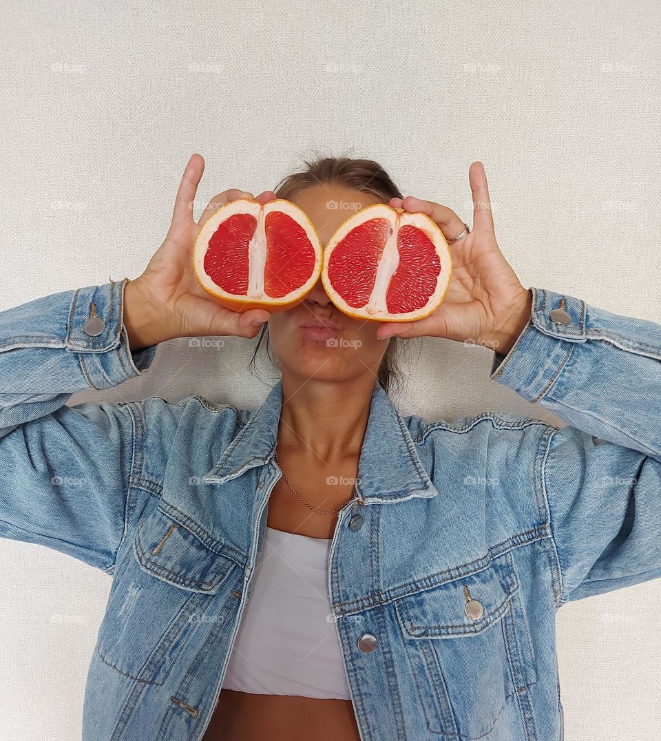 Woman holding red circle fruit