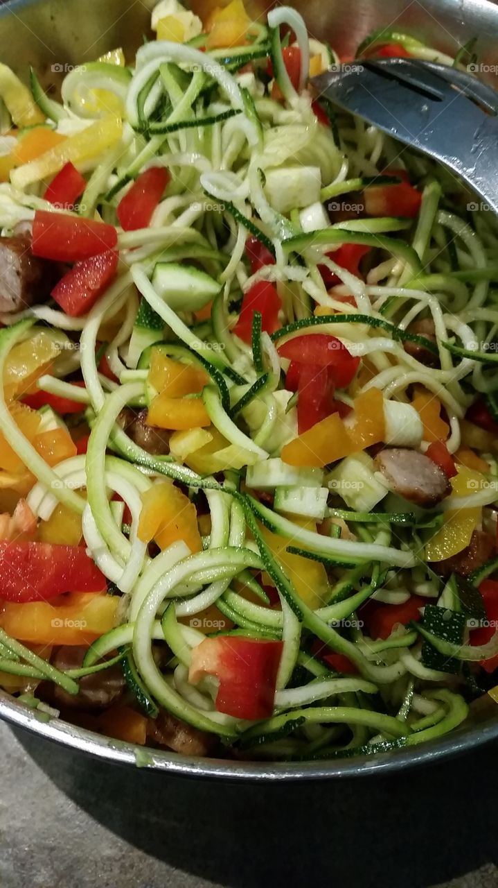 No noodle spaghetti salad: zucchini, bell peppers, avocado, turkey sausage, olive oil, basil.