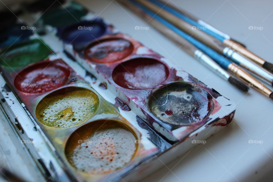 Close-up of watercolour paint with brush