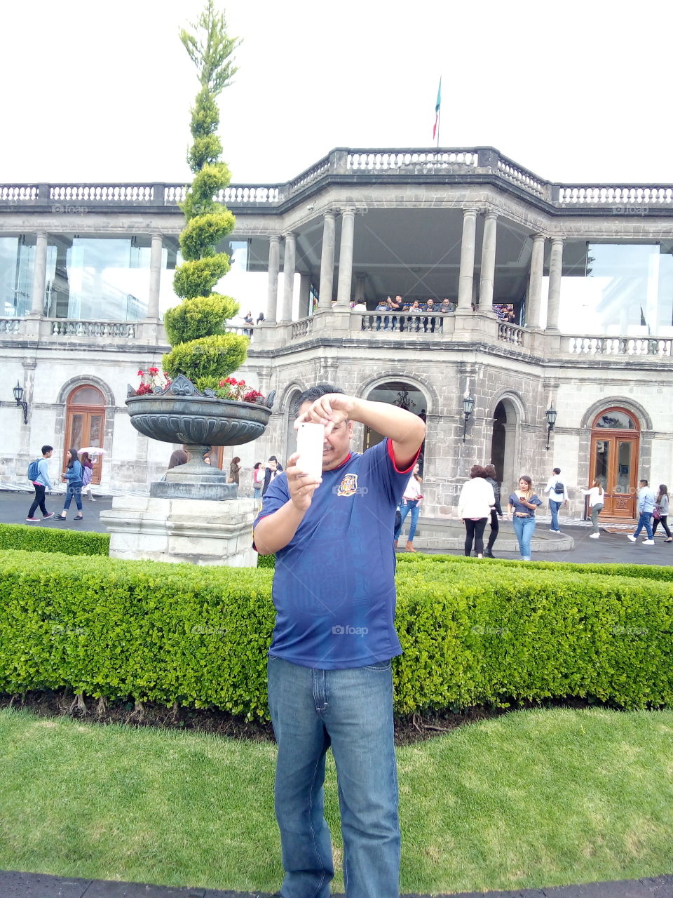 persona tomando fotografía con célular hawei, de fondo parte del castillo de Chapultepec, museo en la cdmx