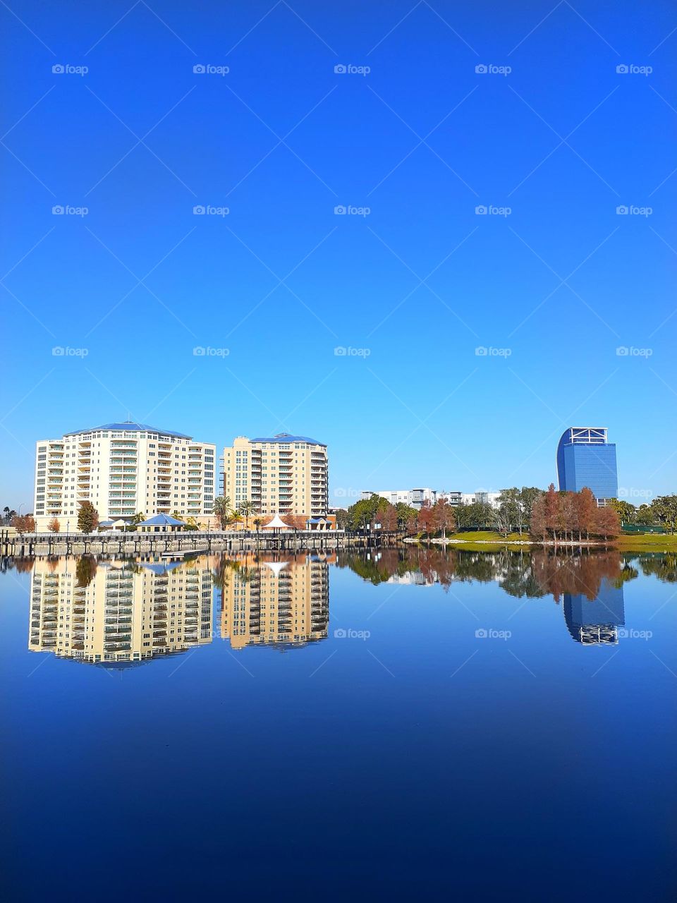 A lakescape view at Cranes Roost Park of the lake and surrounding buildings. One of the buildings shown is known as the Eyesore on I4.