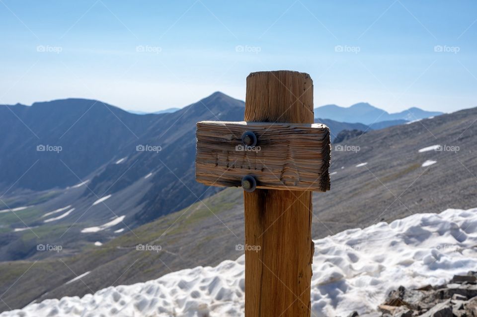 Trail sign on mountain summit. 