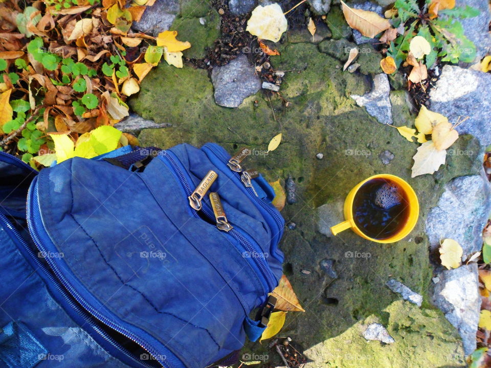 blue backpack and a cup of coffee