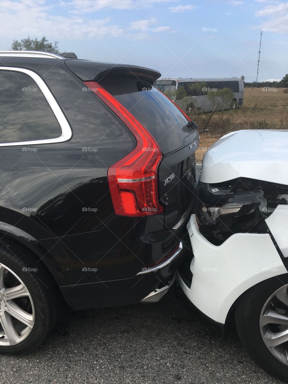 Car crash on the road black  Volvo XC90 and white Land Rover 