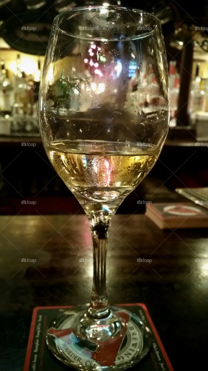 single wine glass at a bar