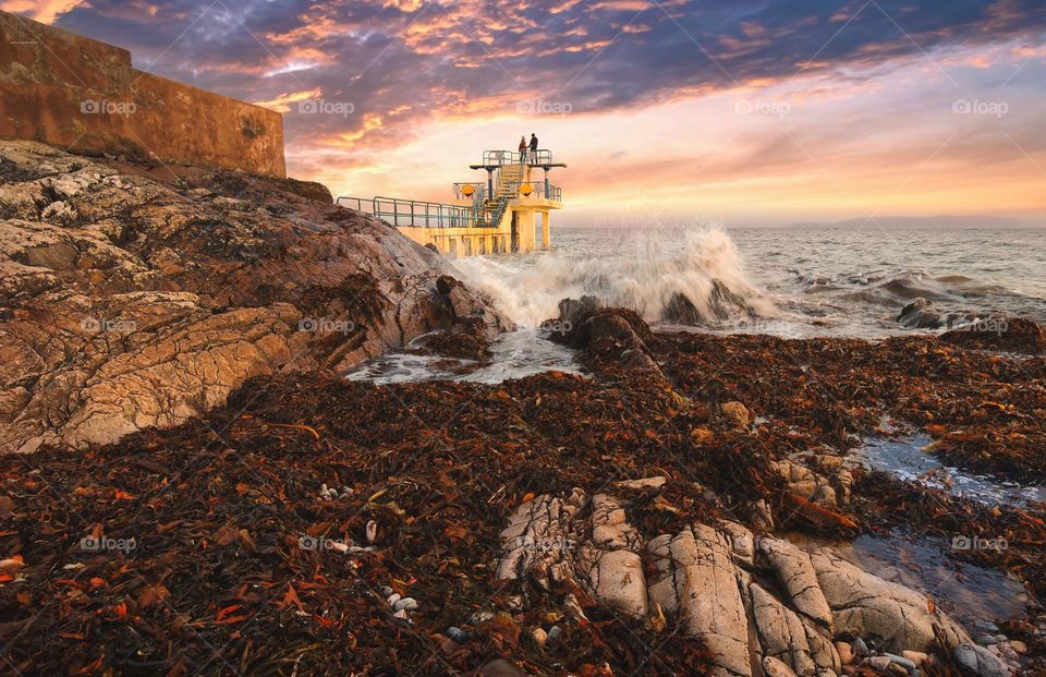 Couple in love at Blacrock diving tower on Salthill beach in Galway, Ireland