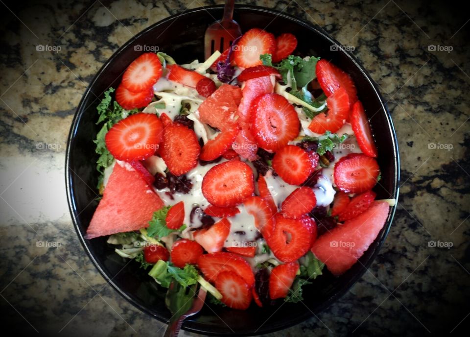 Sweet Kale Strawberry Salad with dried cranberries, watermelon in poppyseed dressing