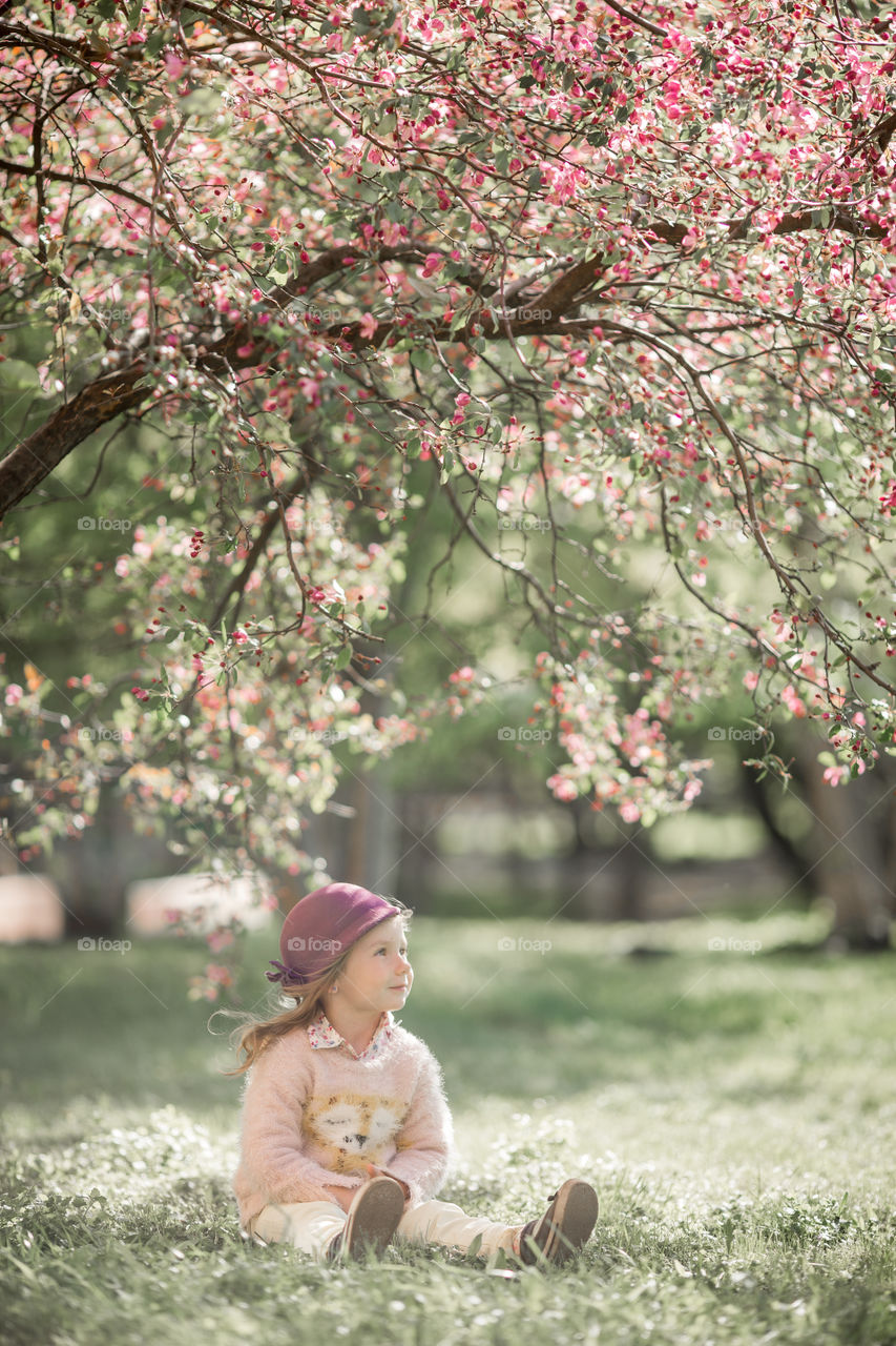 Cute Little girl in a blossom park