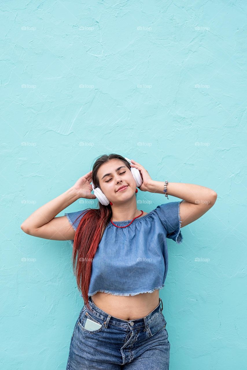 woman listen to the music blue wall