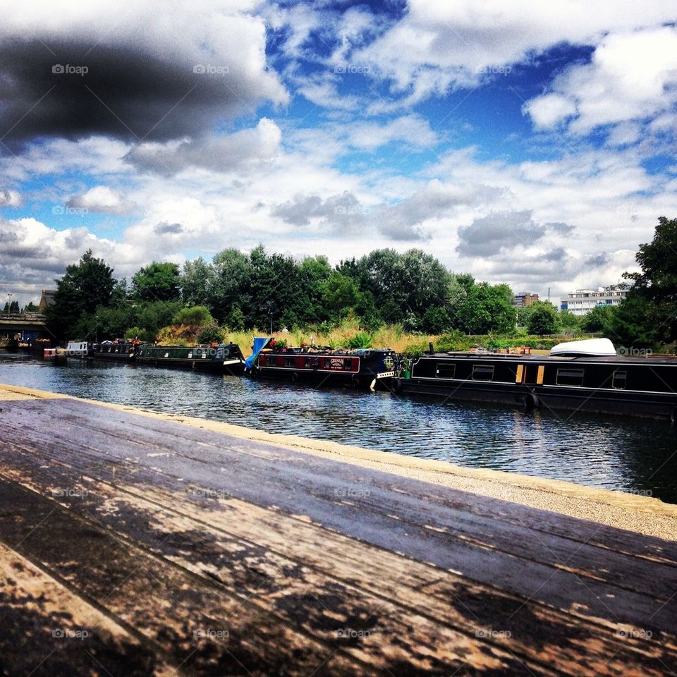 Narrowboats line the bank of Regents Canal, East London.