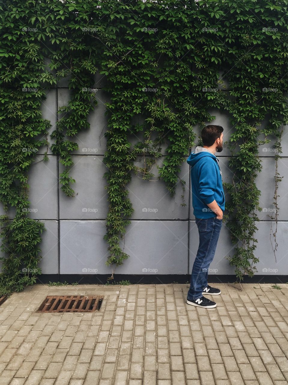 Young man standing near wall