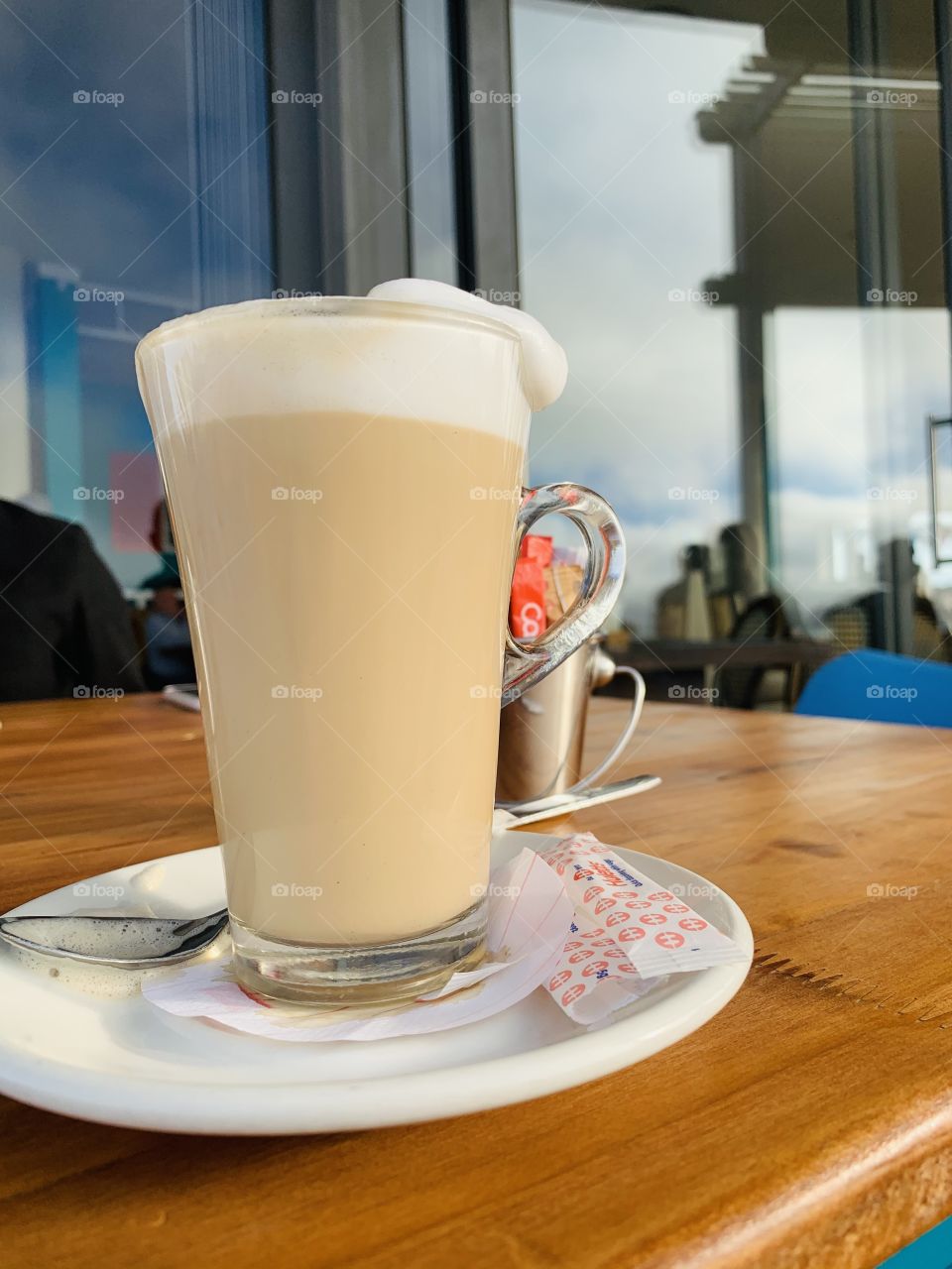 A glass of creamy cafe late on a jetty restaurant.