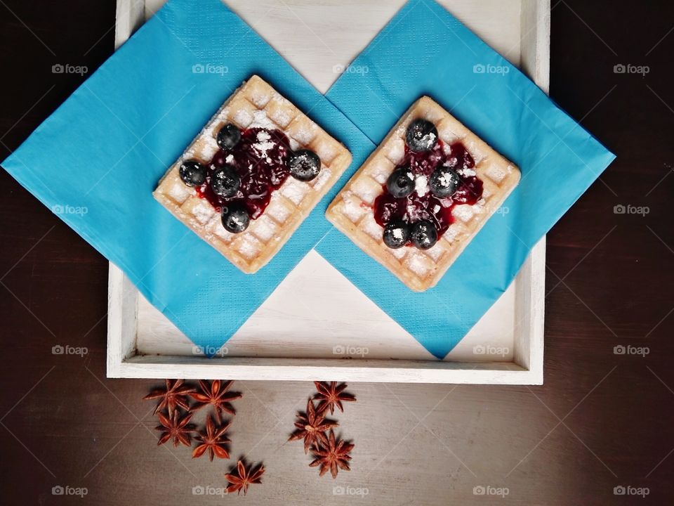 Healthy Christmas sweets with fruits, jam and dark chocolate on a rustic background