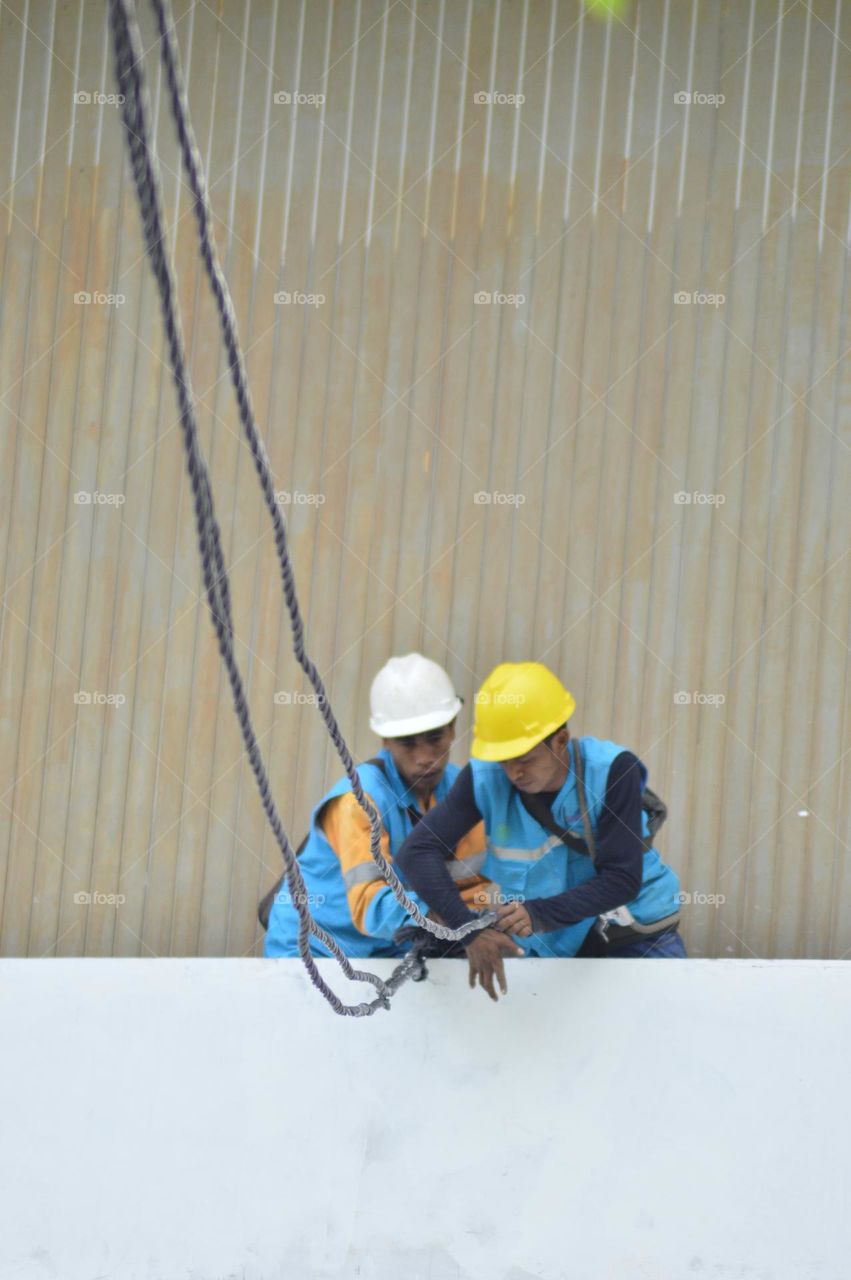 two workers are repairing power lines.  Jakarta, Sunday 14 January 2023