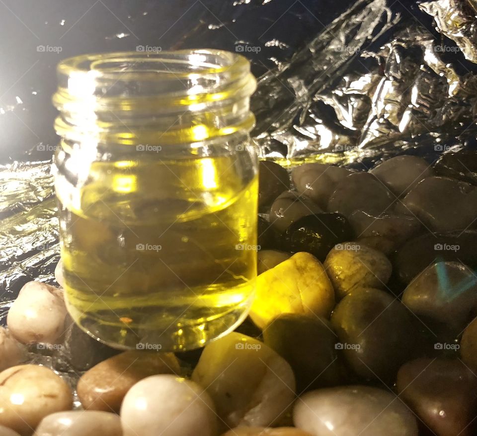 CBD oil from hemp in a glass jar on stones and pebbles 