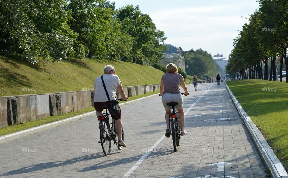 people riding bike on a street