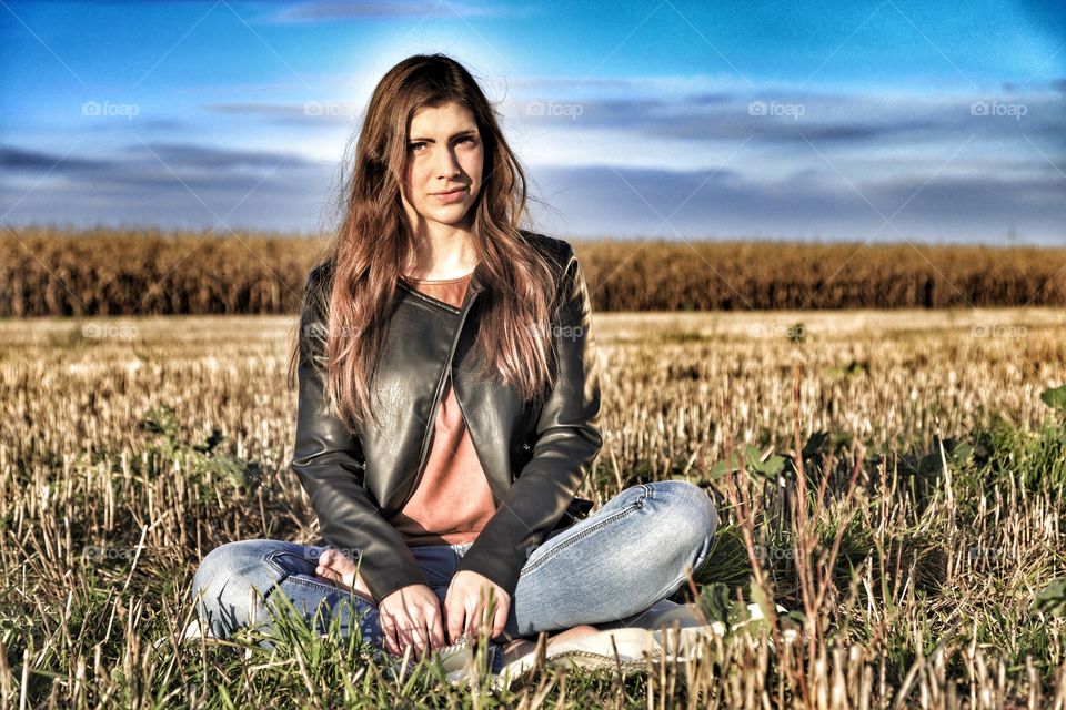 Young woman sitting on field