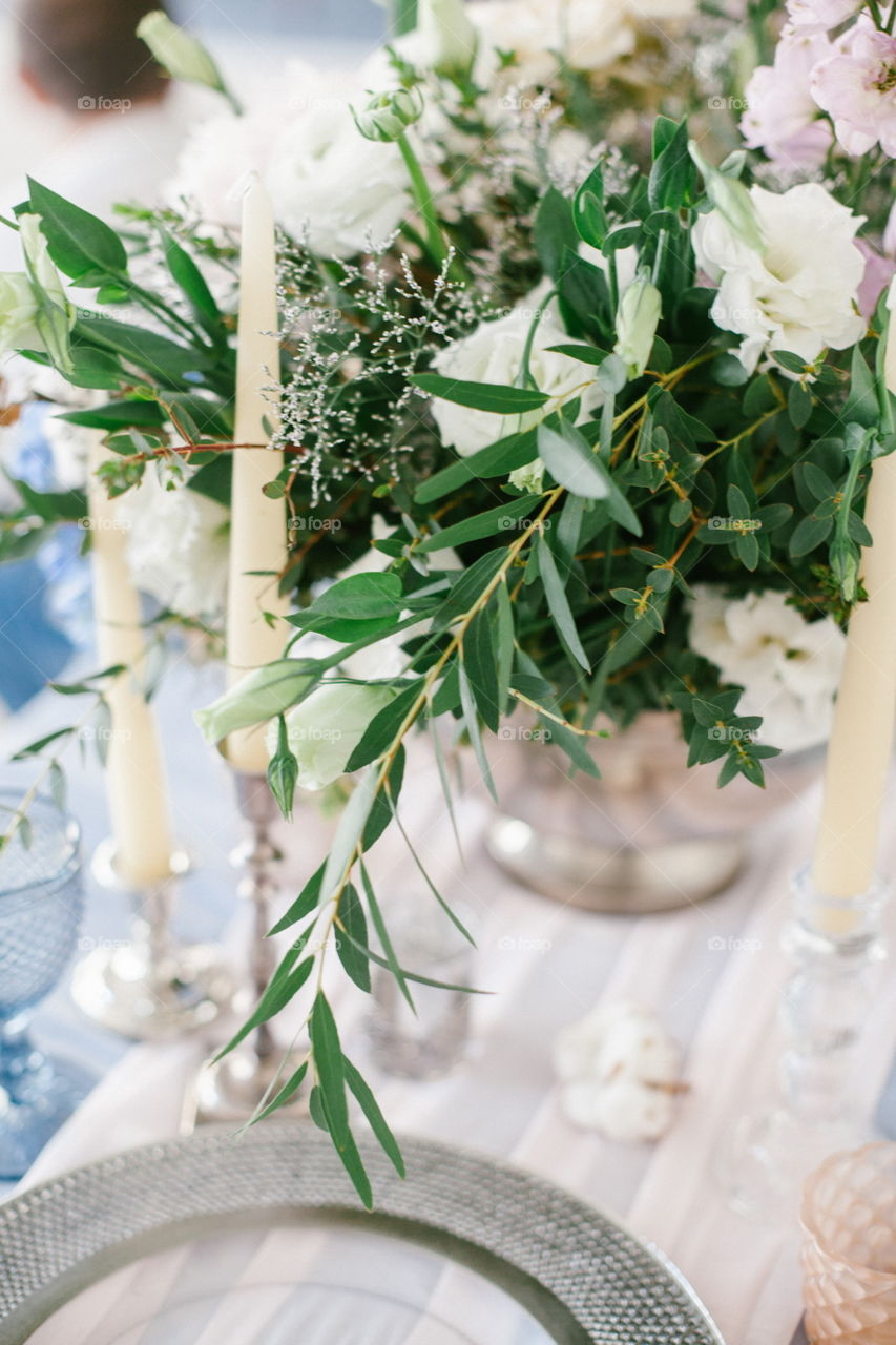 Silver candlestick as element of festive table wedding centerpieces decorations.