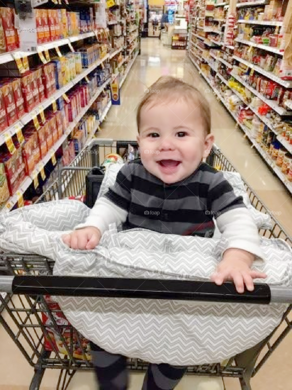 Baby loves grocery shopping and can't stop smiling